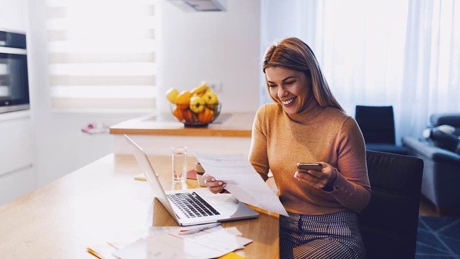 Woman reviewing credit report at home