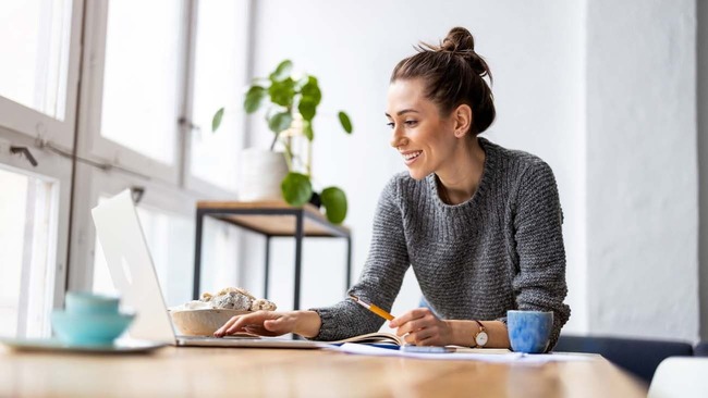 Woman working on laptop at home